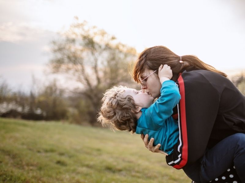 Mother and son playing in a field