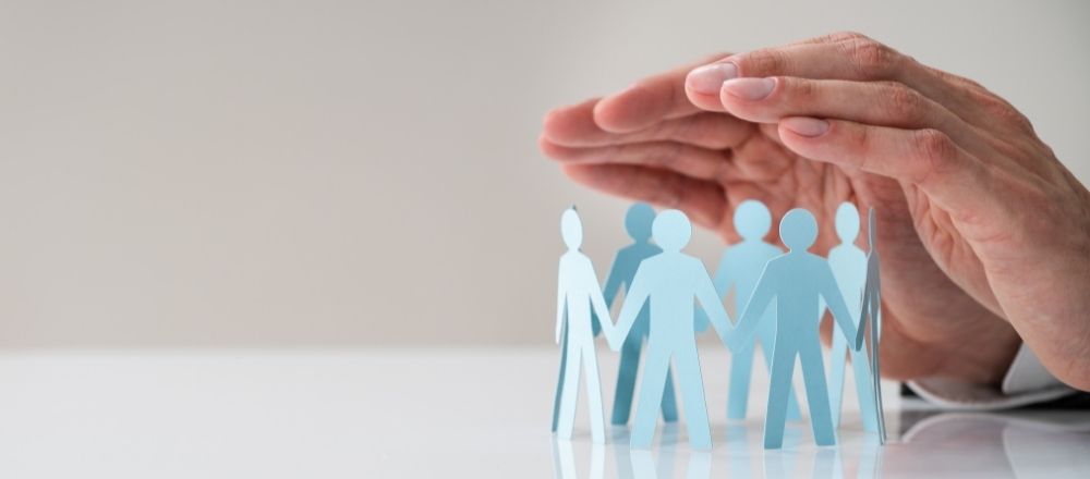 Hands protecting family or employees